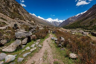 Old trade route in Himalaya surrounded with stones to Tibet from Chitkul village from Sangla Valley