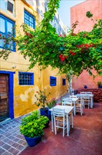 Street cafe in scenic picturesque streets of Chania venetian town with couloful old houses. Chania greek village in the morning. Chanica