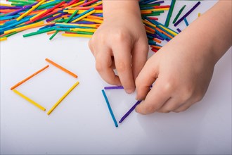 Kid making rectangular and triangle shape as creative concept