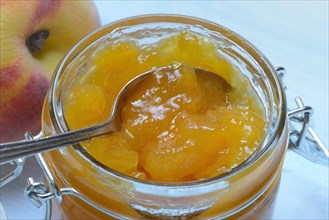 Peach jam in glass and peach