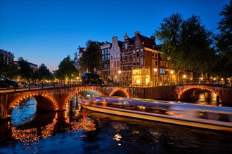 Night view of Amsterdam cityscape with canal