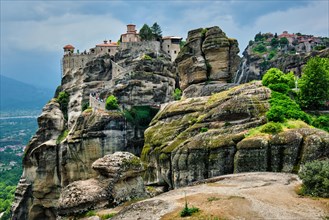 Monastery of Varlaam monastery and Monastery of Great Meteoron in famous greek tourist destination Meteora in Greece on sunset with scenic scenery landscape