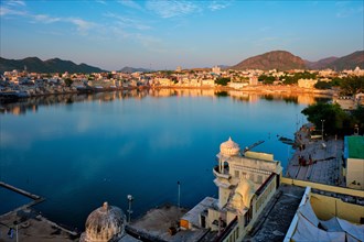 View of famous indian hinduism pilgrimage town sacred holy hindu religious city Pushkar amongst hills with Brahma mandir temple