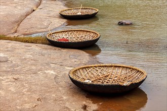 Traditional wickerwork coracle boats in Hampi on bank of Tungabhadra river