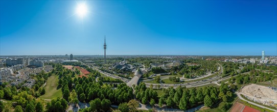 Panoramic view over Munich with the Olympic Tower in the Olympic Park under a blue sky in spring