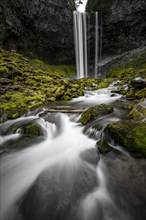 Waterfall cascading over rocky outcrop