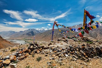 Buddhist prayer flags lungta with Om mani padme hum mantra written on them in Spiti Valley in Himalayas