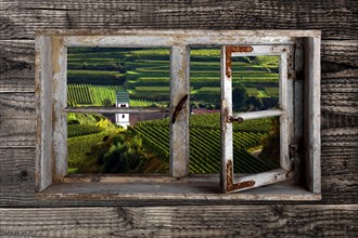 View through a rustic wooden window on Oberbergen