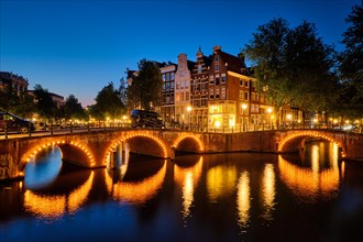 Night view of Amterdam cityscape with canal