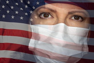 Doctor or nurse wearing medical face mask and scrubs with ghosted american flag