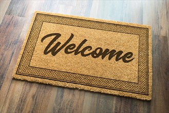 Welcome mat on A wood floor background