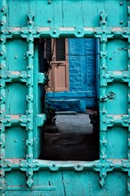 Old wooden door in blue houses of Jodhpur