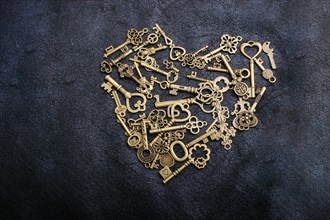 Retro metal keys form a heart shape on black