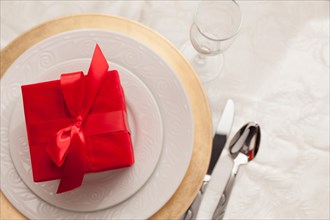 Christmas gift with place setting at table