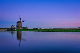 Netherlands rural landscape with windmills at famous tourist site Kinderdijk in Holland in twilight