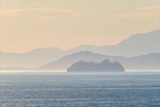 Cruise liner ship silhouette in haze in Mediterranea sea