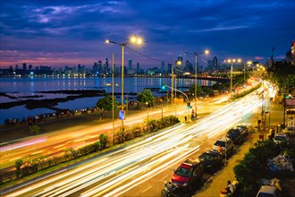 Mumbai famous iconic tourist attraction Queen's Necklace Marine drive in the night with car light trails. Mumbai