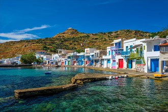 Picturesque Greek fishing village with white houses and colorful doors and windows