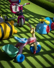 Plastic vehicle toys on green lawn