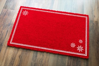 Blank holiday red welcome mat with snow flakes on wood floor background