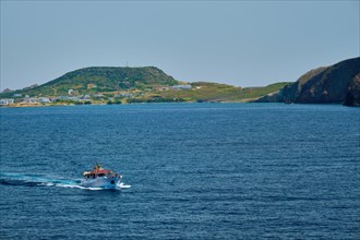 Greek fishing boat in blue waters of Aegean sea near Milos island