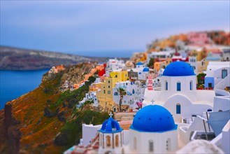 Famous greek iconic selfie spot tourist destination Oia village with traditional white houses and church in Santorini island on sunset in twilight