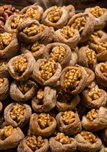 Pile of whole fresh walnuts without nutshells in fig