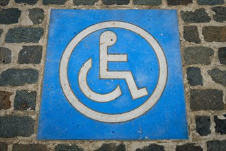 Disabled handicapped Parking Sign on cobblestone parking lot