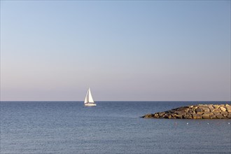 Coast with sailboat in San Lorenzo al Mare