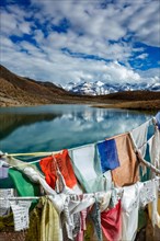 Prayer flags lungta with Om mani padme hum. . mantra written on them and Dhankar Lake. Spiti Valley