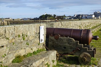 Old cannon on the quay wall of the port of Roscoff