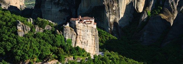 Panorama of Monastery of Rousanou in famous greek tourist destination Meteora in Greece on sunset with scenic landscape