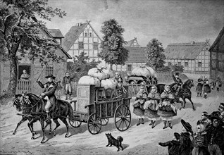 The bride's beds are driven through the village by a wagon