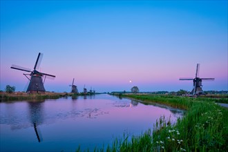 Netherlands rural landscape with windmills at famous tourist site Kinderdijk in Holland in twilight