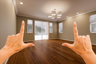 Female hands framing empty room of new house