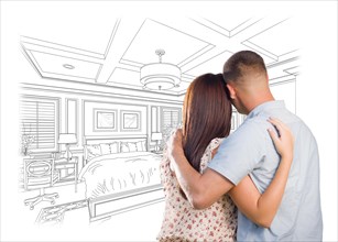 Curious young military couple looking over custom bedroom design drawing