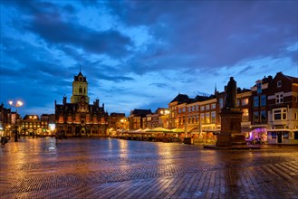 Delft City Hall and Delft Market Square Markt with Hugo de Groot Monument in the evening