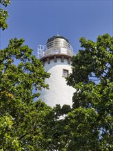 White lighthouse Langer Erik between trees