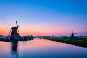 Netherlands rural lanscape with windmills at famous tourist site Kinderdijk in Holland in twilight