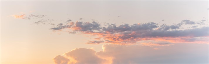 Large pink cloud at sunset in spring. panorama