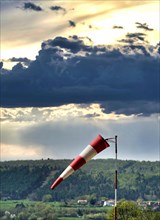 Windsock and cloudy sky