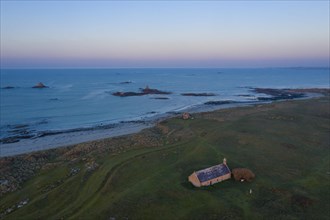 Aerial view of Ker Emma sandy beach and Keremma dunes with Chapelle Saint-Guevroc just in front of sunset