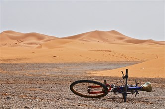 Bicycle lying on stony ground