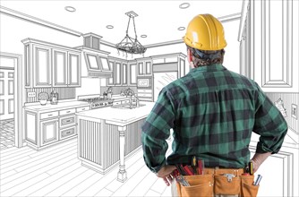 Male contractor with hard hat and tool belt looking at custom kitchen drawing on white