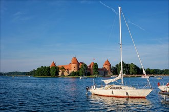 Yacht boats and Trakai Island Castle in lake Galve in day