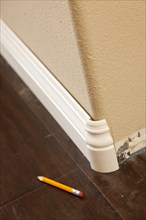 New baseboard and bull nose corners with laminate flooring abstract