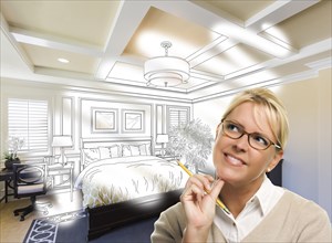 Daydreaming creative woman with pencil over custom bedroom design drawing and photo combination