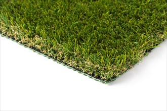 Section of artificial turf grass on white background