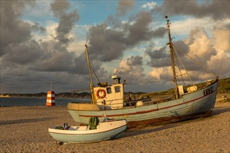 Fishing boats in the evening light at the natural harbour of Vorupoer