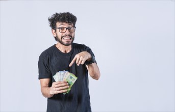 Man pointing at the money in his hand